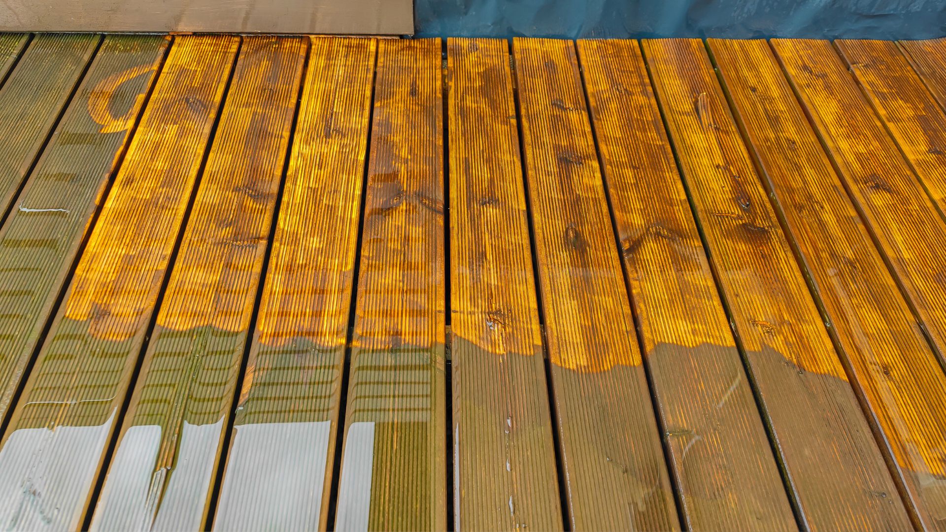 A wooden deck with a blue umbrella on it